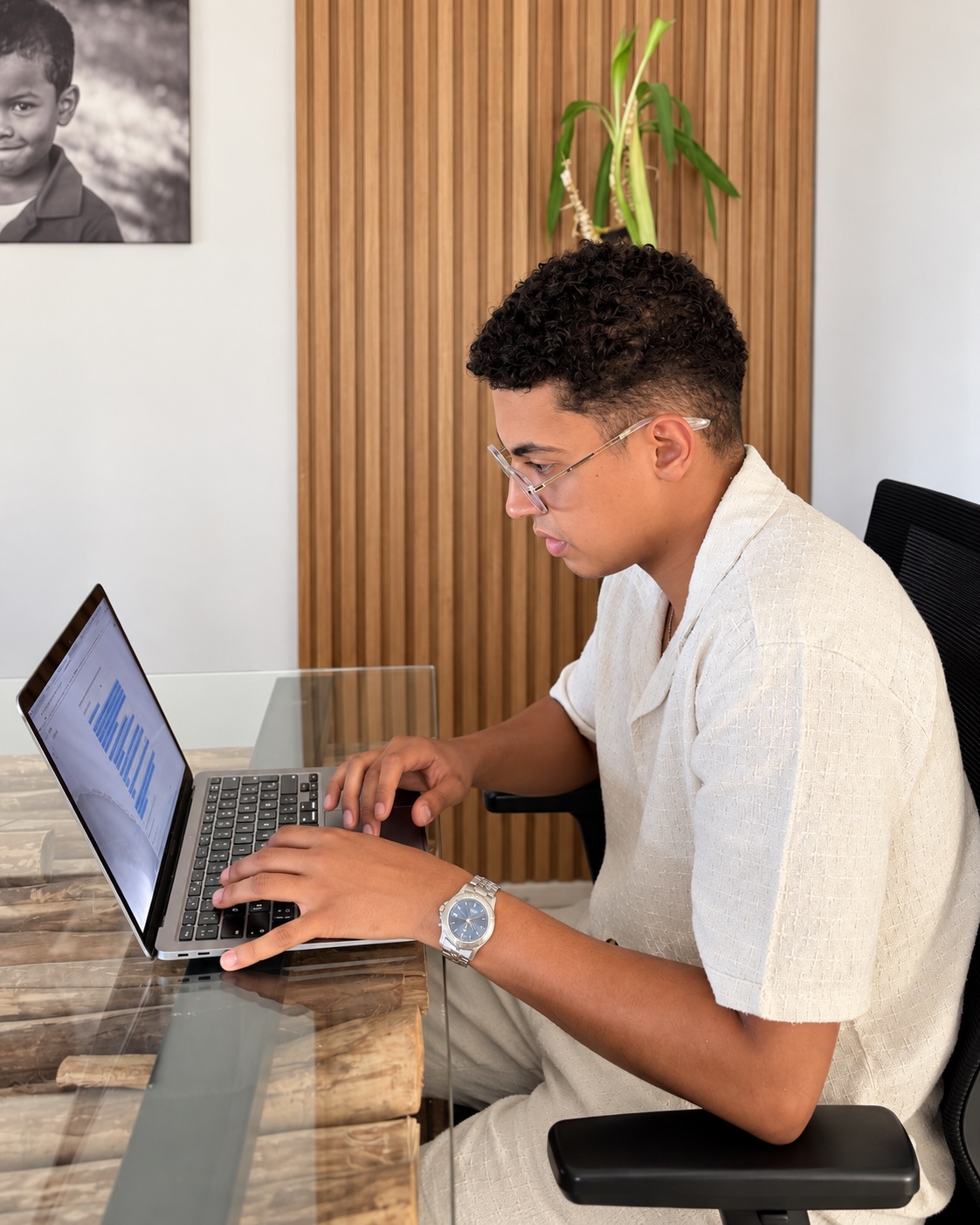 Othman working on his laptop at the office